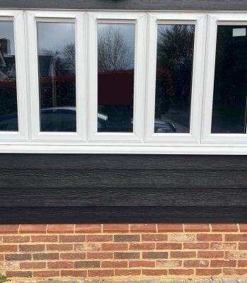 Up and over door replaced by large window in garage conversion to office in Suffolk by Buildright Suffolk