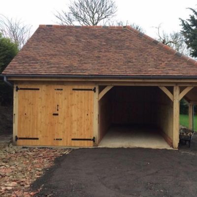 Front view of two bay cart lodge with wood store in Suffolk by Buildright Suffolk