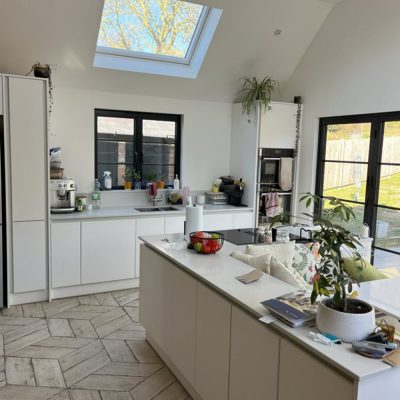 Roof lights and folding doors bring natural light into bungalow kitchen extension